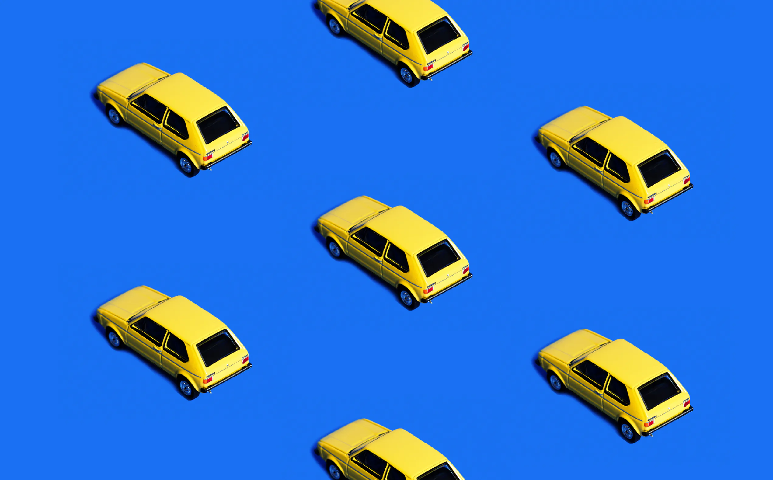 Repeating yellow cars on a blue background.